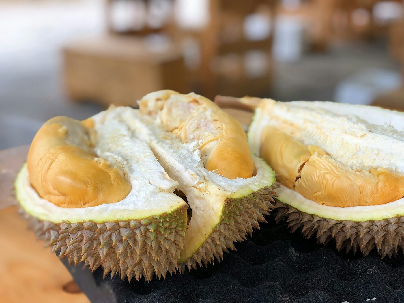 Opened durian showing golden creamy flesh — the premium tropical export fruit